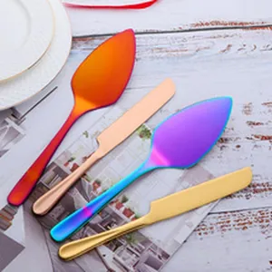 Close-up of colorful iridescent stainless steel serving spatulas and knives set