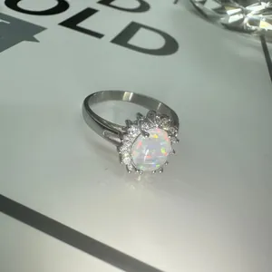 Elegant stainless steel sunflower ring featuring an oval opal with crystal halo detail