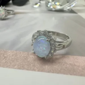 Elegant sunflower ring featuring an oval opal and sparkling crystals in stainless steel