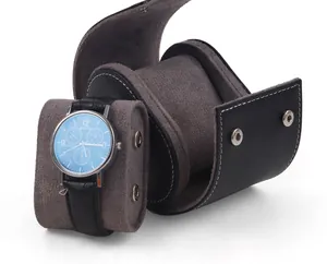 Detailed view of the elliptical PU leather watch box featuring a removable grey suede cushion