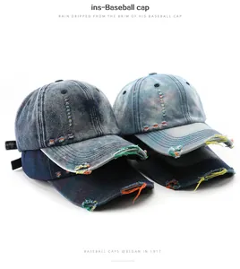 Close-up detail of distressed washed denim baseball caps with colorful stitching accents