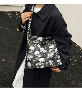 Detailed outdoor shot of a large skull and flower print tote bag with LOVE strap