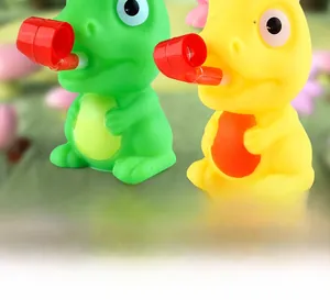 Jouets à presser dinosaures vert et jaune avec sifflets rouges pour jeu sensoriel