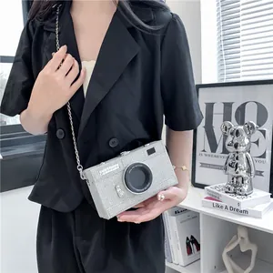 Detail shot of the creative silver glitter camera shaped box bag with metallic chain strap