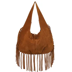 Detailed macro shot of a brown suede hobo shoulder bag with stylish long fringe tassels