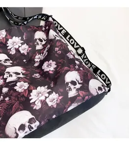 Detailed view of gothic skull and floral pattern on a large capacity canvas tote bag
