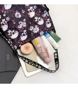 Detailed view of large capacity skull floral tote bag with daily essentials inside