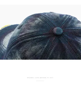 Close-up detail of a vintage washed denim baseball cap crown showing stitching and texture