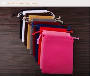 Close-up of colorful velvet drawstring storage pouches for jewelry and accessories.