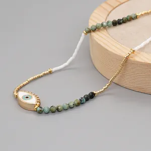Detailed close-up of Evil Eye necklace featuring turquoise beads and golden accents