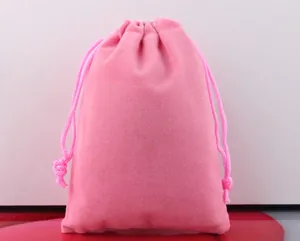 Close-up of a soft pink velvet drawstring pouch designed for jewelry and accessory storage