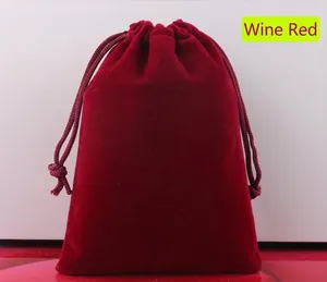 Detailed view of the burgundy velvet drawstring pouch showing texture and color