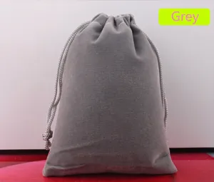 Detailed view of a grey velvet drawstring pouch showing soft fabric and cord closure