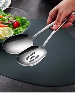 Detail view of premium stainless steel serving spoon and slotted spoon in dining setting