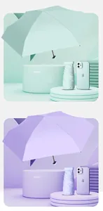 Mini pocket umbrella in Morning Mist Green and Light Elegant Purple compared to a phone