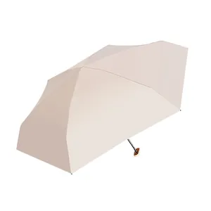 Minimalist 5-fold beige sun umbrella with portable mini design for UV protection