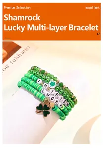 Close-up detail of St. Patrick's Day green layered bracelet set with shamrock charms.