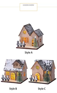 Detailed view of three wooden LED glowing Christmas house styles with snow effect