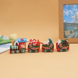 Detailed view of a miniature wooden Christmas train with festive figurines on a table.