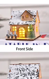 Detail of LED illuminated wooden Christmas cabin house ornament with warm front glow