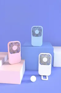 Three colorful portable USB mini fans shown on stylish geometric blocks for summer cooling