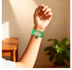 Close-up detail shot of green St. Patrick's Day beaded bracelets with lucky clover charm