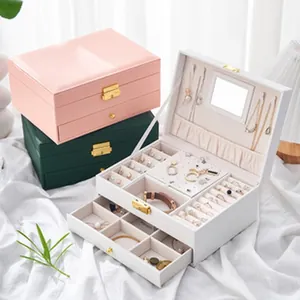 Close-up of a 3-layer jewelry organizer showing ring slots and necklace hooks with mirror
