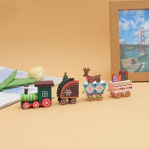Detailed view of 4-piece wooden Christmas train ornament on decorative desk setup.