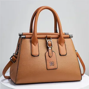 Elegant caramel tan handbag featuring lychee grain leather texture and top handles