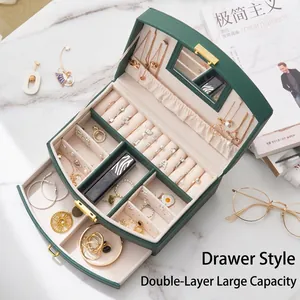 Detailed view of the interior compartment of a green double-layer jewelry storage box