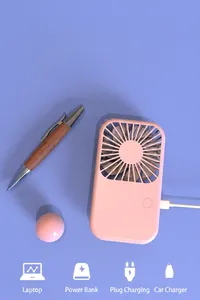 Detailed view of the pink mini handheld fan showcasing its USB charging capability and design