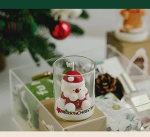Detailed macro shot of a Santa Claus shaped scented candle in a festive glass cup