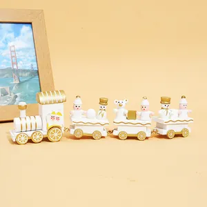 Detail showing a white and gold wooden Christmas train ornament for holiday decor