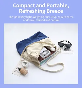 Portable mini USB fan inside a tote bag showing its compact size for travel.