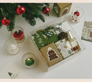 Luxury Christmas fragrance gift set featuring scented candles and perfume in acrylic box