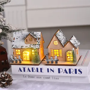 Wooden Christmas LED glowing cabin miniature house on decorative books for table decor