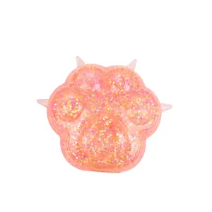 Cute pink cat paw squishy toy with iridescent gold glitter filling on white background