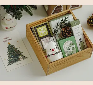 Detailed view of a festive Christmas gift box containing a scented candle and cream.
