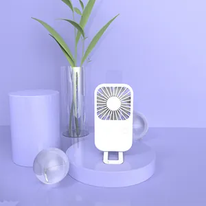 Portable white handheld USB rechargeable fan on a minimalist purple decorative display stand