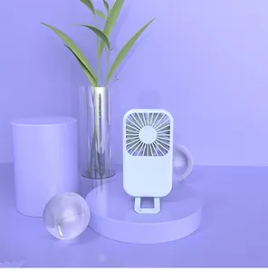 Close-up of a lavender mini portable USB fan standing on a circular display platform
