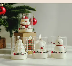 Detailed view of four festive Christmas scented candles featuring Santa, snowman, and bear shapes