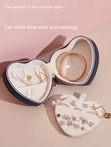 Navy blue heart-shaped jewelry box featuring a removable earring insert and soft lining