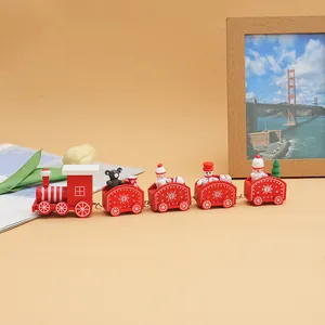 Close-up detail of a charming red wooden Christmas train set with festive toy figures