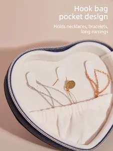 Detail view of heart-shaped jewelry box hooks and pocket for necklace storage.