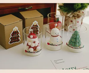 Detailed view of Christmas themed scented candles with Santa and snowman figures