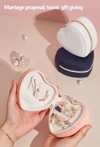 Portable heart-shaped travel jewelry box with multiple compartments for rings and earrings