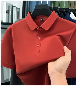 Close-up detail of a premium red men's polo shirt showing the pique fabric and collar tag