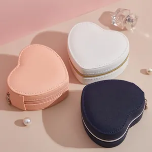 Heart-shaped jewelry travel storage boxes in pink, white, and navy blue faux leather