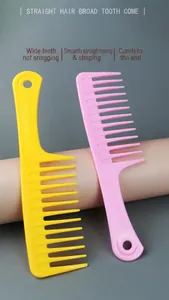 Close-up of pink and yellow wide-tooth detangling combs for curly hair and scalp massage