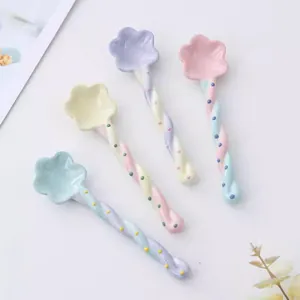 Close-up detail of cute flower-shaped ceramic dessert spoons and coffee stirrers